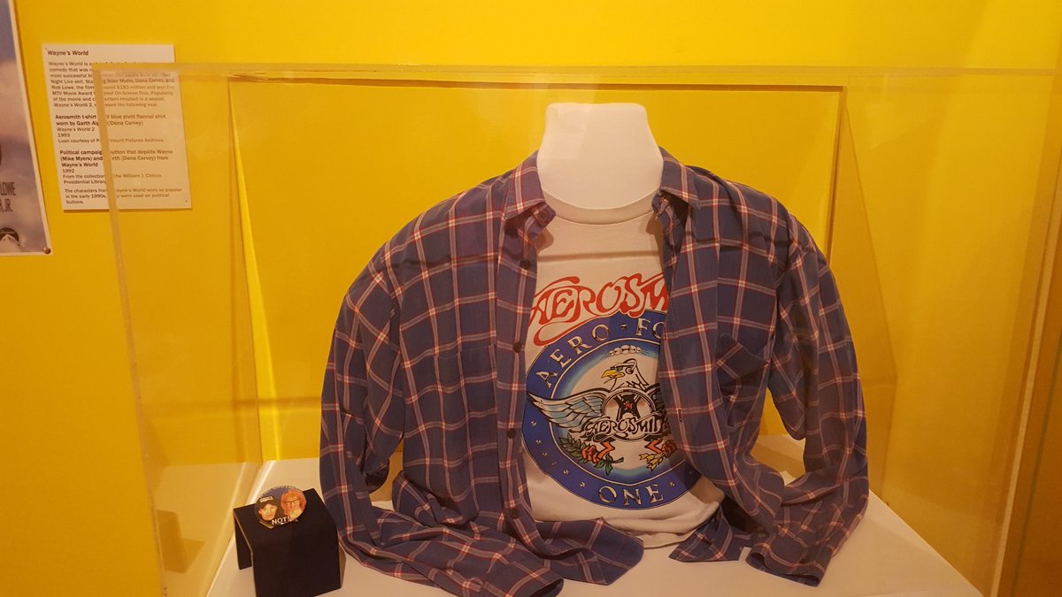 sarahkendzior's tweet photo. The Bill Clinton Museum in Little Rock has Mulder and Scully's FBI badges, Buffy's stake, the Seinfeld ASSMAN license plate, Garth's shirt from Wayne's World, and the couch from Friends https://t.co/V0M6TrgVBi