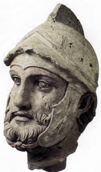 A sculpted head (broken off from a larger statue) of a Parthian warrior wearing a Hellenistic-style helmet, from the Parthian royal residence and necropolis of Nisa, modern Turkmenistan, 2nd century BC.