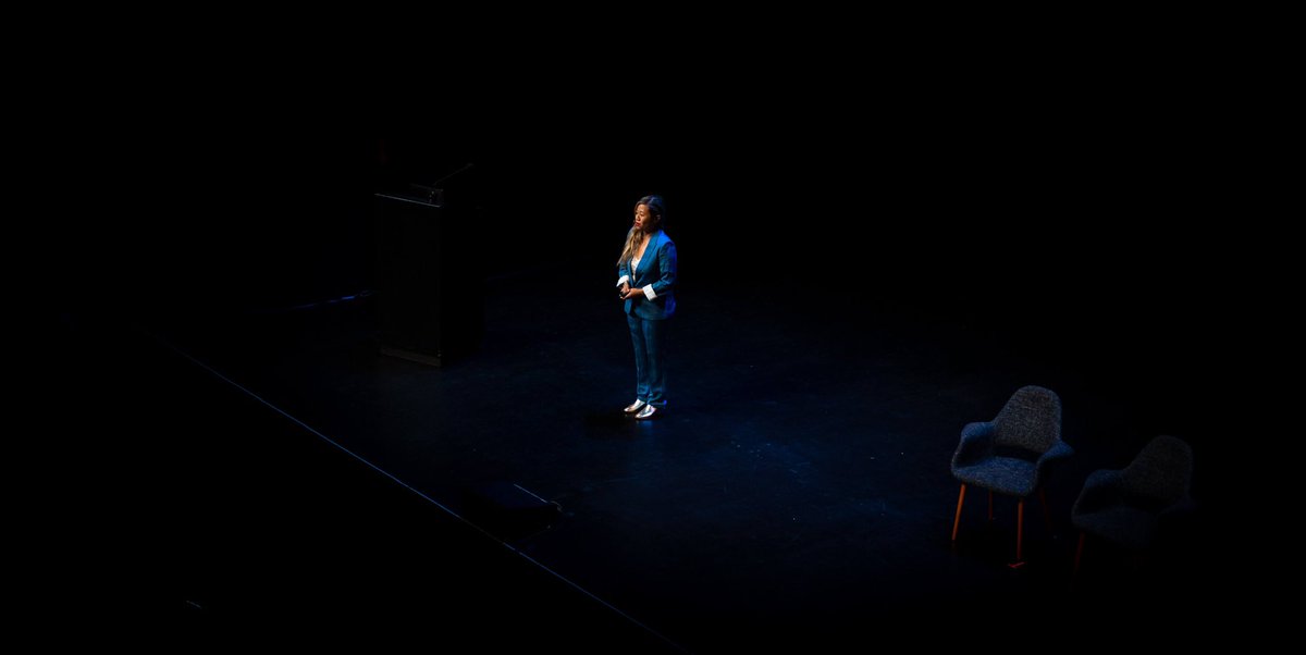 Me very small on stage delivering a talk