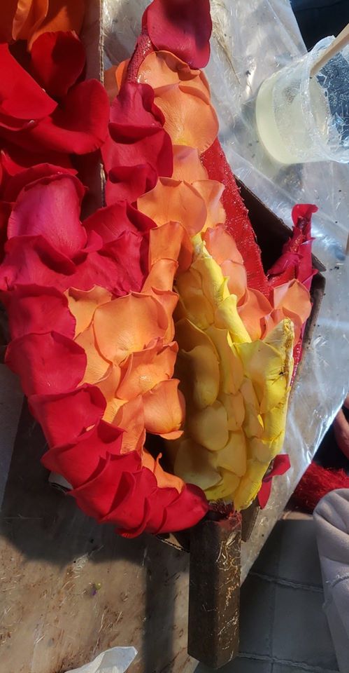 LCFloat's tweet photo. The final full day of decorating brings on roses in many forms. Rose petals going on the flames coming out of the rear engines, and vialed roses going onto the base of the float. First judging is at 3:18pm today! #RoseParade #LCFTRA #RoseParade2020 https://t.co/zBhMXJ6egT