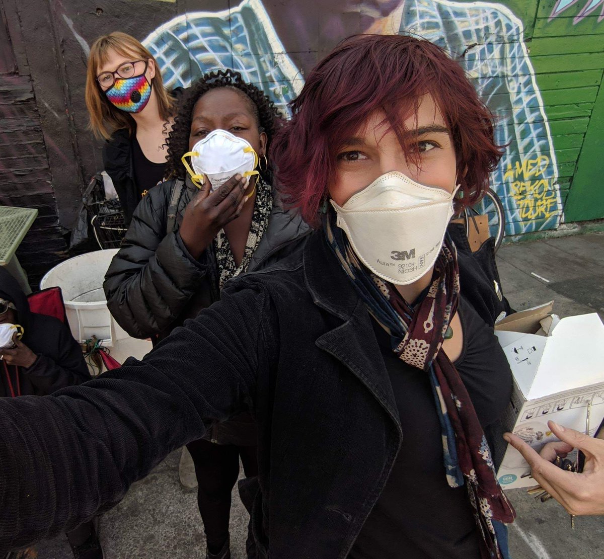volunteers pose handing out masks in oakland 