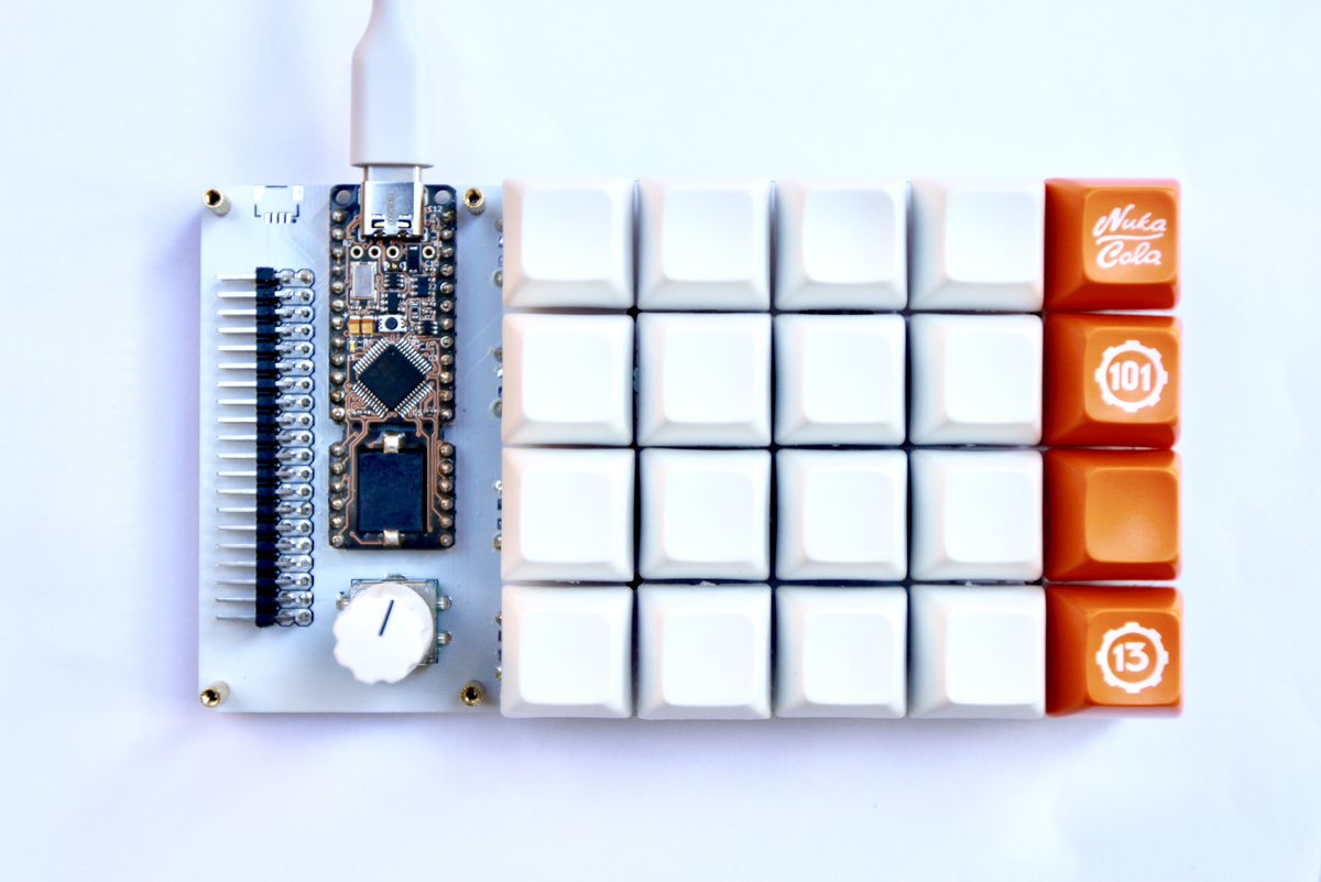 Thedora 4x5 keyboard with rotary encoder and header pins for access to all pins on the Proton C.