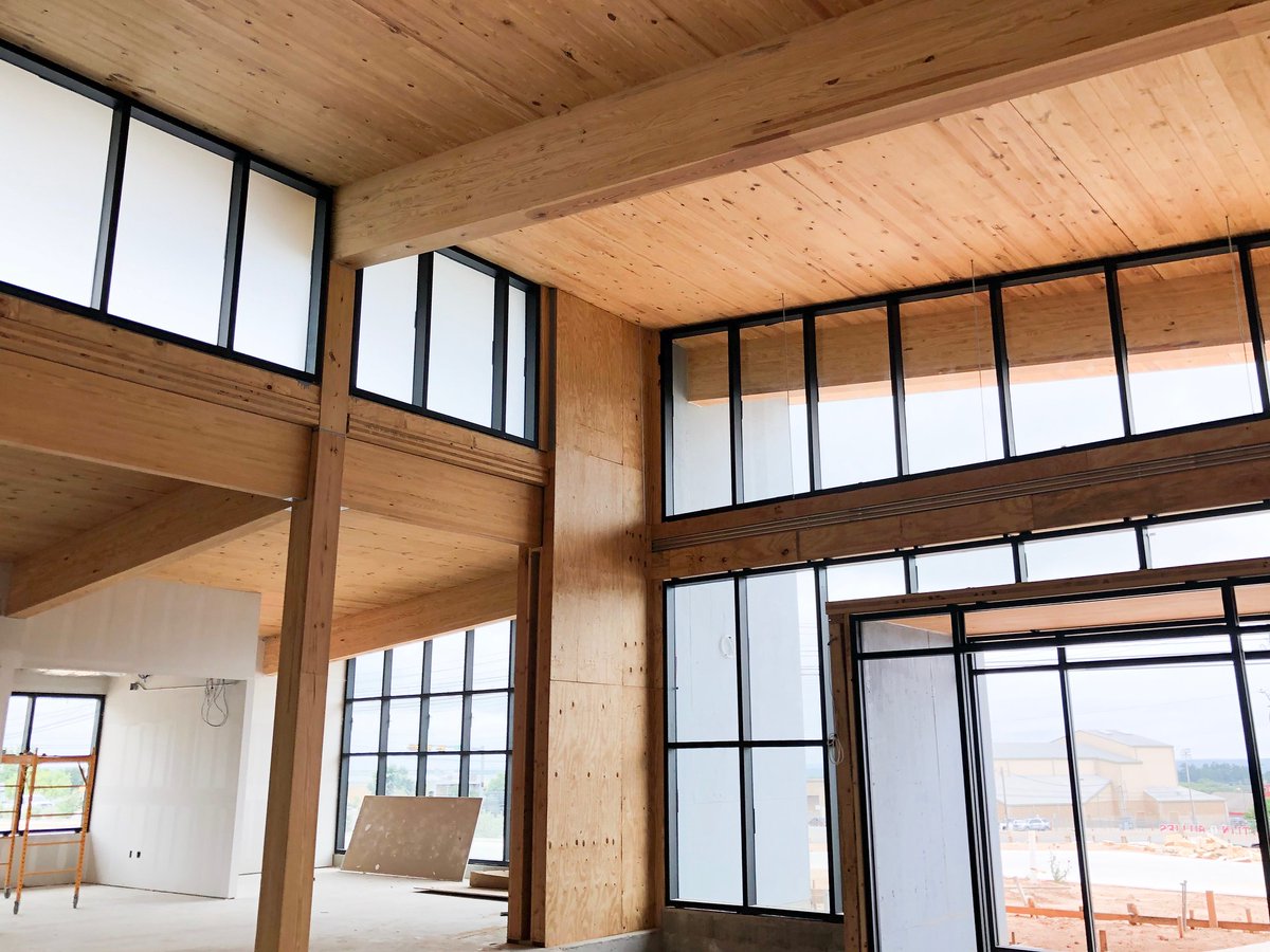 TXForestService's tweet photo. Texas A&amp;M Forest Service personnel visited the site of the new First United Bank building in Fredericksburg, Texas. The project marks the first time certified Southern Yellow Pine cross-laminated timber panels are being used in the construction of a Texas building. #TFS2019 #CLT https://t.co/8mjcXtm121