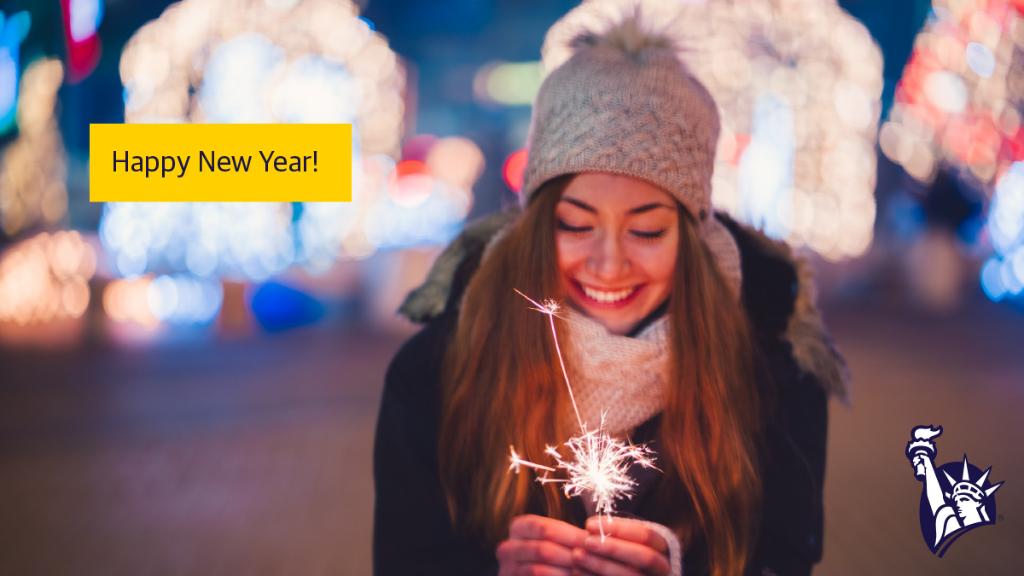 A woman with long brown hair wearing a gray hat, white scarf, and black winter jacket holds a sparkler in front of her. The caption says "Happy New Year!"
