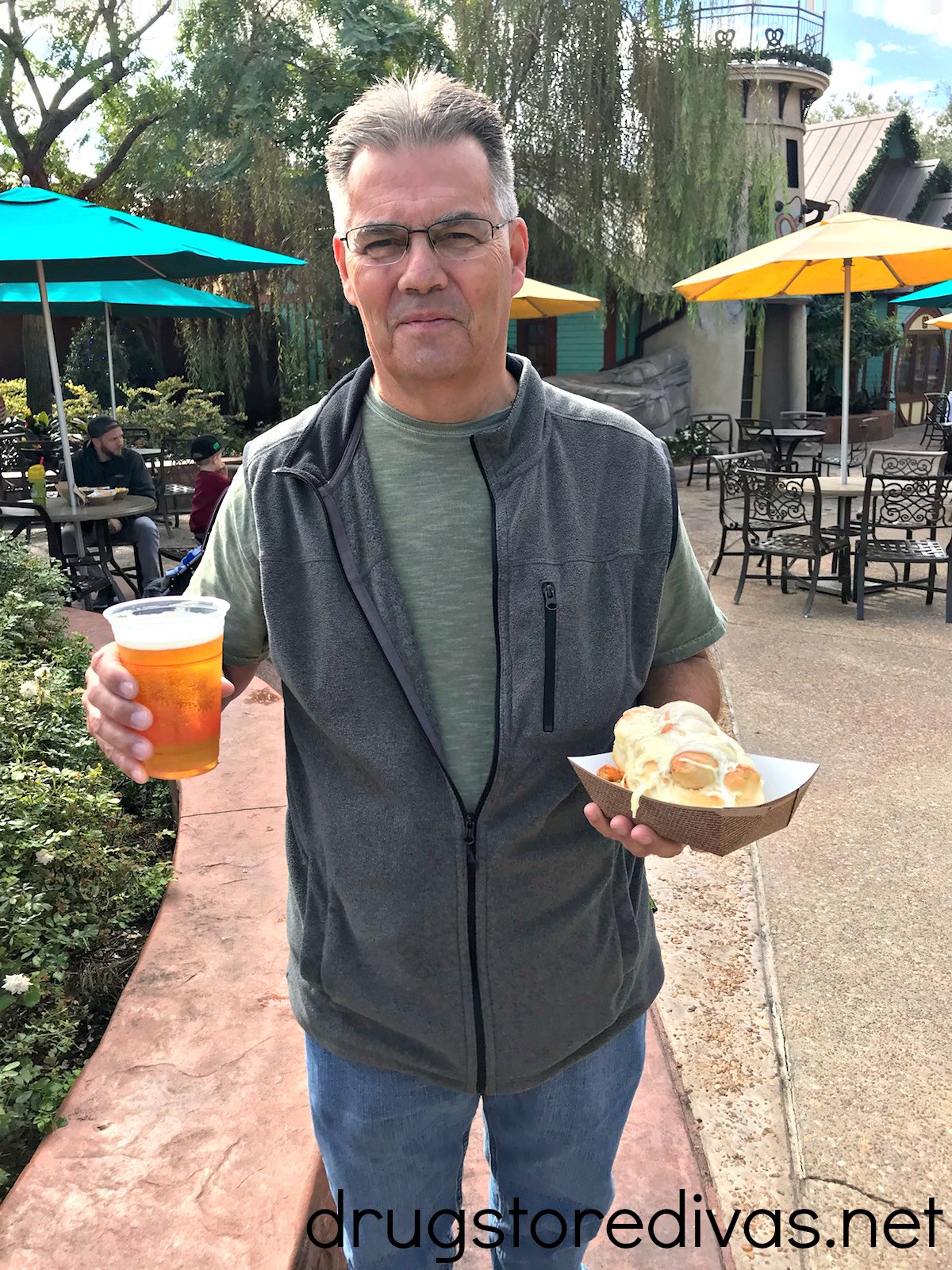 A man holding a beer and food in SeaWorld Orlando.