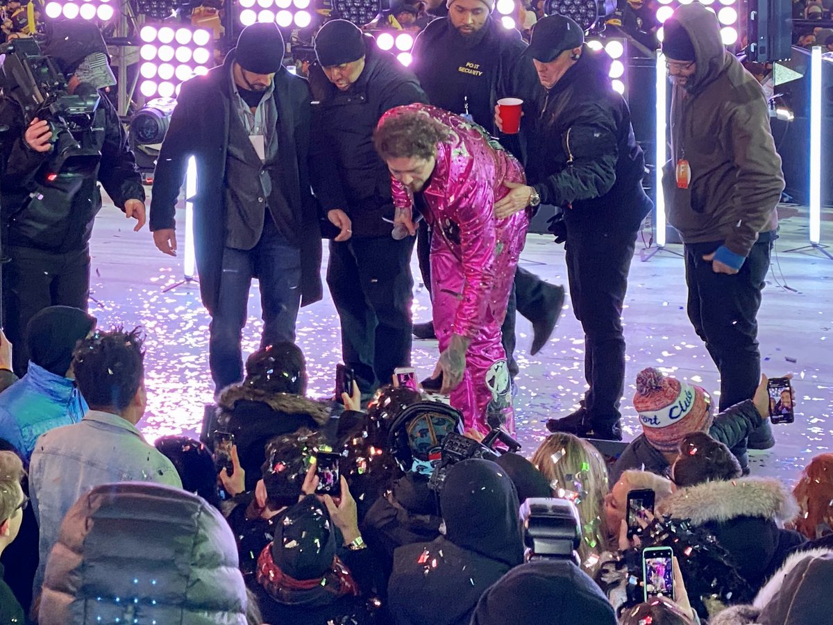ChrisPollone's tweet photo. Here’s the aftermath of Post Malone falling off the stage tonight. He had just hugged Seacrest and went to shake fans’ hands and his foot slipped off the stage. After he and fans got over the initial shock he smiled for a selfie as roadies helped him back up. #nyc #nye https://t.co/mTt50qd2gd