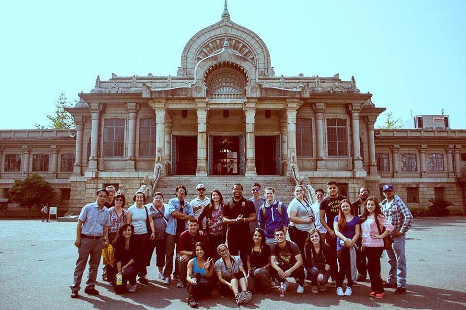 Aidan Hill standing in front of a Buddhist Temple with members of an American delegation to Japan