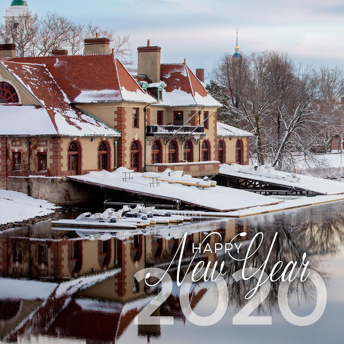 The boat house and its reflection in the Charles River and words that say "Happy New Year 2020" 