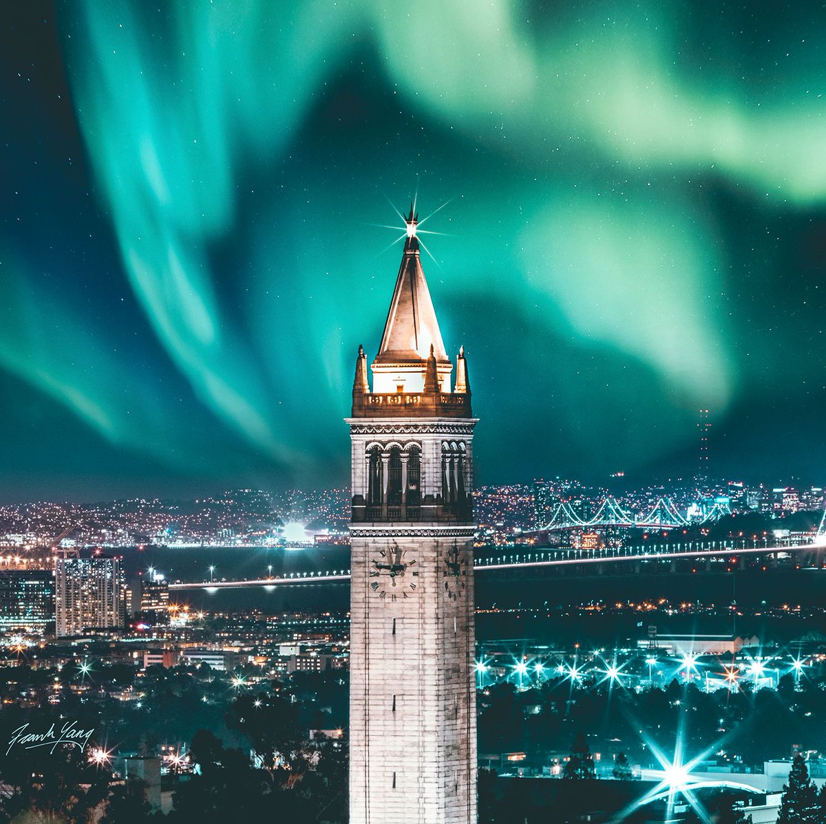 Photo of the campanile with aqua northern lights above.