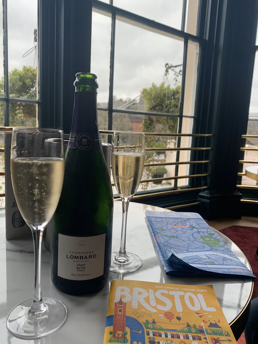 Bottle of champagne with two glasses. Looking over the Clifton Suspension Bridge
