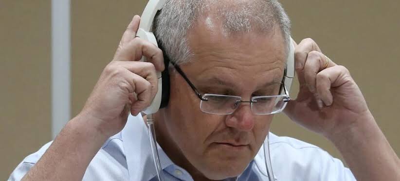 Here Morrison trials his patented #BackgroundNoise cancelling headphones so he can listen unimpeded to #QuietAustralians™️