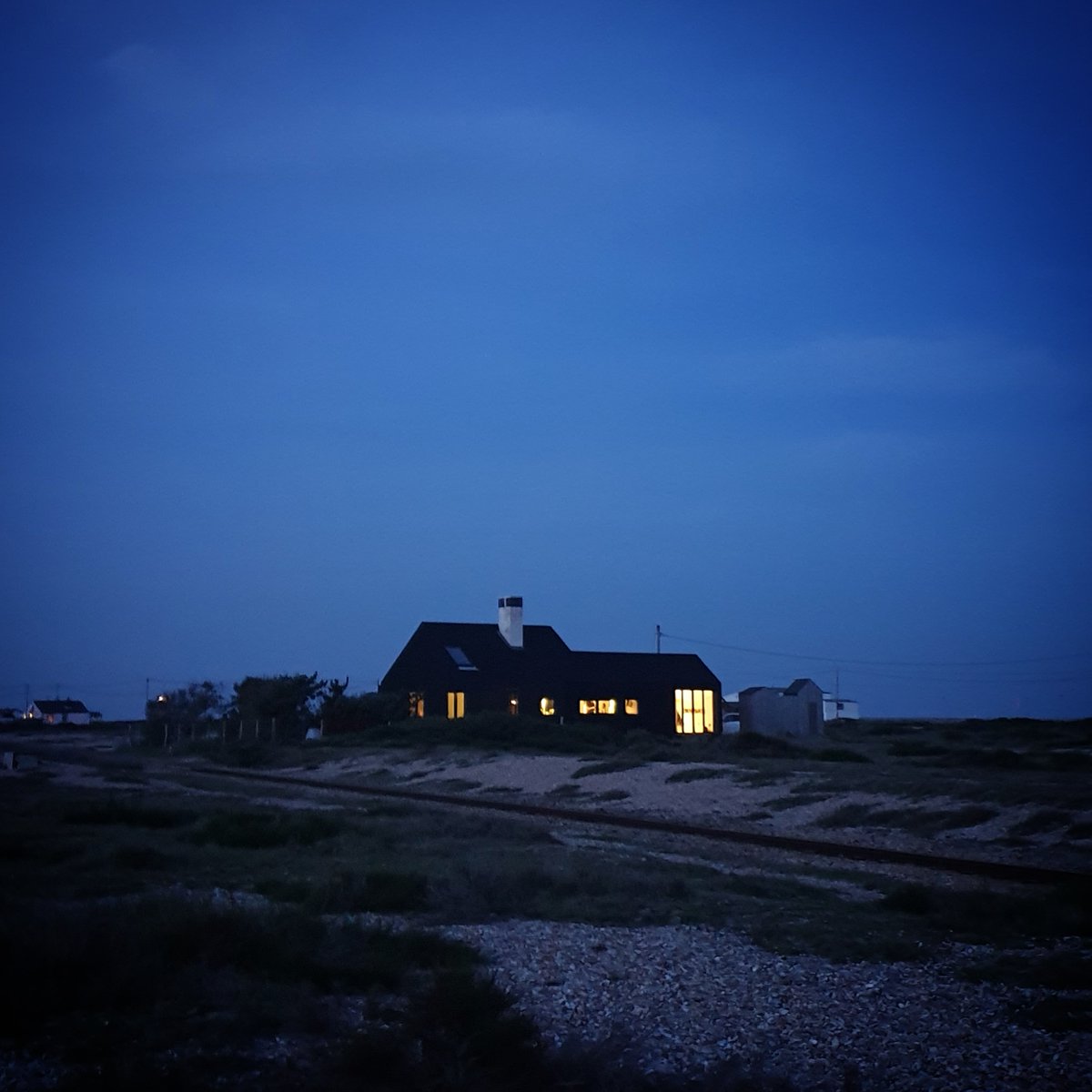Twilight Zone #Dungeness. Stay at #ShingleHouse to explore this alluring landscape that has been attracting artists and nature lovers for years. Book now  living-architecture.co.uk/book.asp
#unusualplaces #escapethecity #modernhome #holidayrental #architecture #romneymarsh