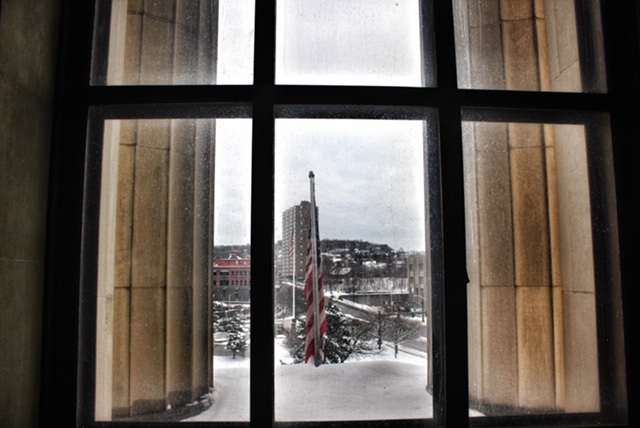 View from the Aud's memorial hall, monumental columns and large windowpanes in the foreground.