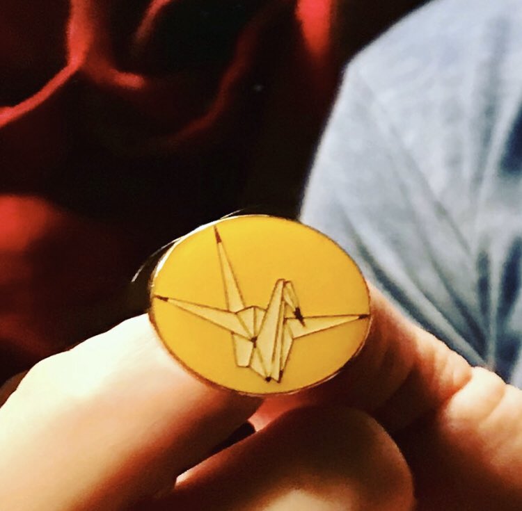 Spdrman3333's tweet photo. A pin given to me from a Hibakusha (a survivor of the US atomic bombings in Japan). Its a constant reminder that war never affects you until it does. Anyone who has been directly involved with war loathes it. Its the privileged and the ignorant who cheer it on. No war with Iran. https://t.co/5R1vT9Tpao