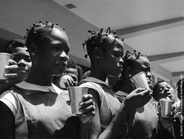 Pupils take milk break at Queen's College in  #Yaba, Lagos, Nigeria, a state secondary school for girls. (June 1959). Photo: by Keystone Features