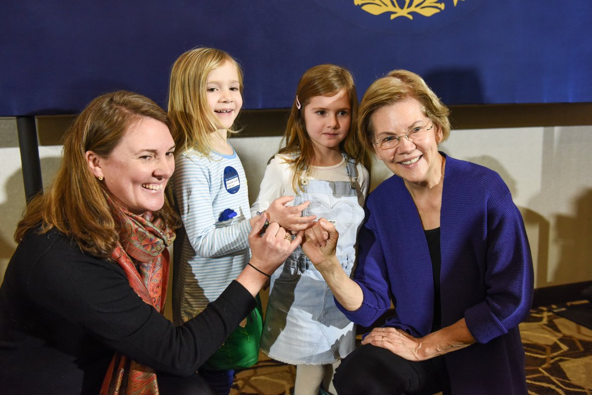 Elizabeth Warren makes a pinky promise at the Concord town hall.