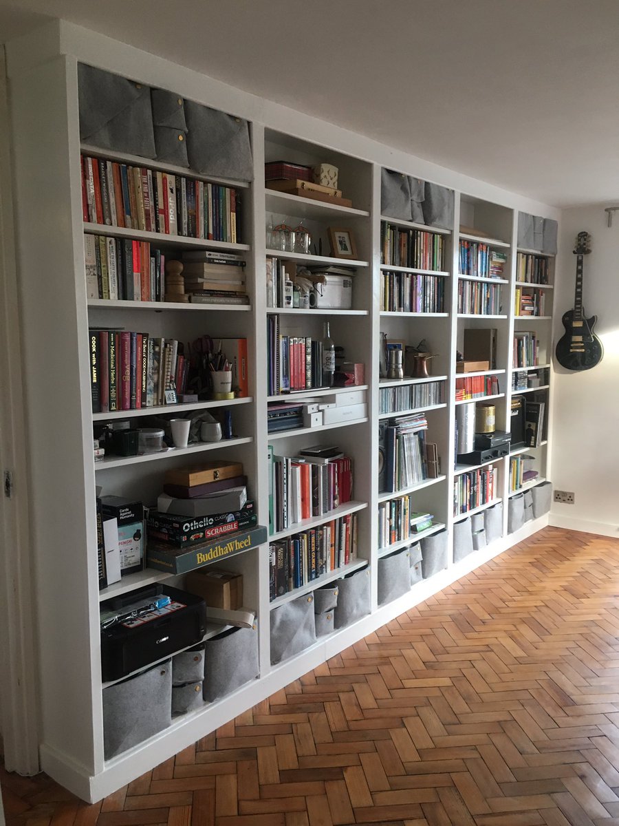 LittleEcoT's tweet photo. Finally finished our built-in bookshelves project (started last year) with a lick of gloss paint. It’s made from cheap wood pieces, left over skirting, &amp; 5 billy bookcases (extended). #IKEAhacking https://t.co/g1DmQkuI55