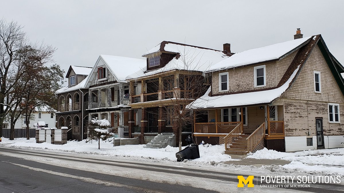 Houses lining a snow covered road in Detroit.