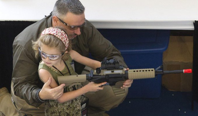 Now I am not saying that this child should be playing with her dolls, but she certainly should not be toying with a weapon of war, this is outright child abuse or at the least child endangerment. No sense or sensibility, this act should be a crime.

#BoycottNRA #Gunsense