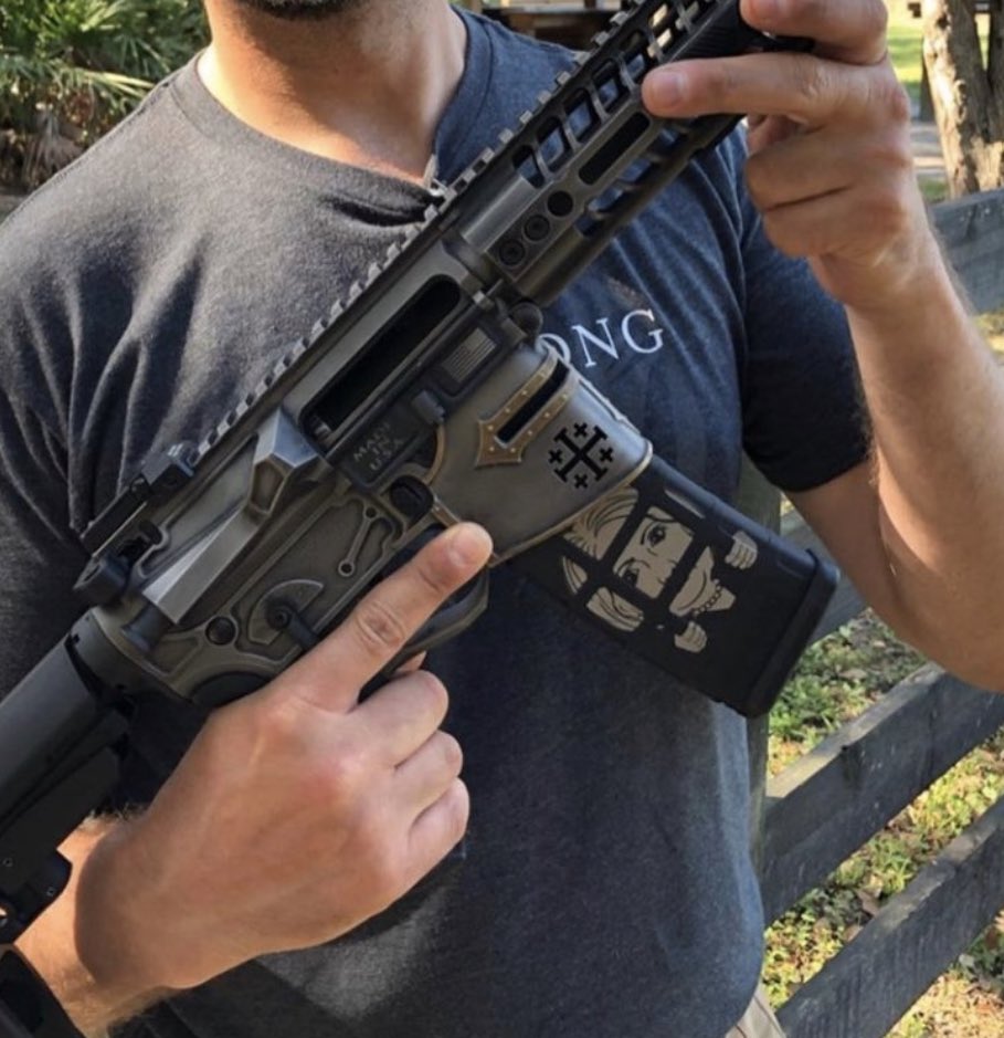 ScottLinnen's tweet image. It’s the impeached president’s namesake son with a gun. With a German Iron Cross. And a former political opponent behind bars on the magazine.