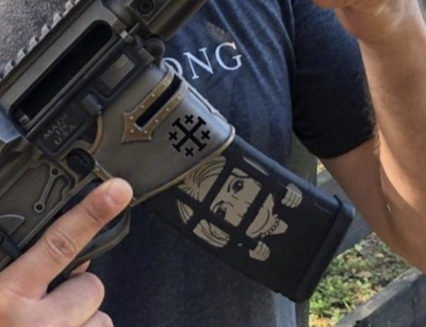 ScottLinnen's tweet image. It’s the impeached president’s namesake son with a gun. With a German Iron Cross. And a former political opponent behind bars on the magazine.