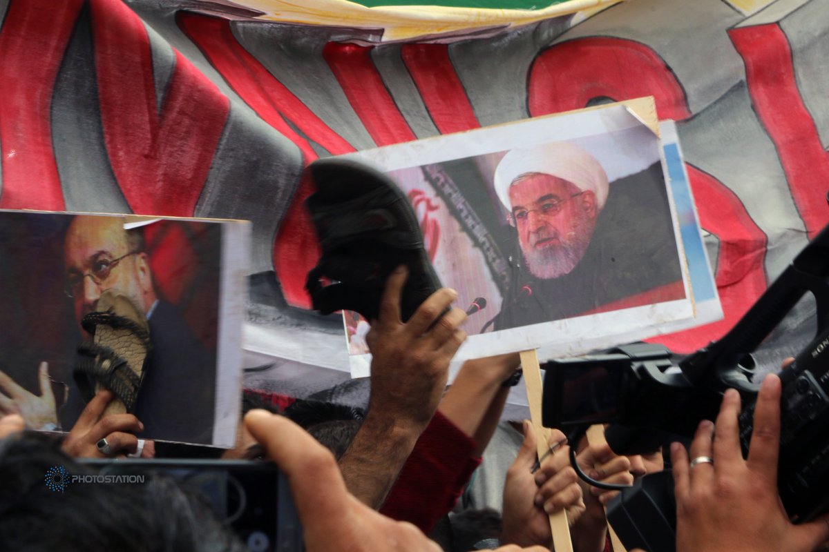 PStationAgency's tweet photo. An protester  as he holds a shoe on a portrait of Iran President Hassan Rouhani In a demonstration in the city of Idlib, October 31, 2019, Photostation, © Abdalrhman Ismail https://t.co/YJFQBv73Qb