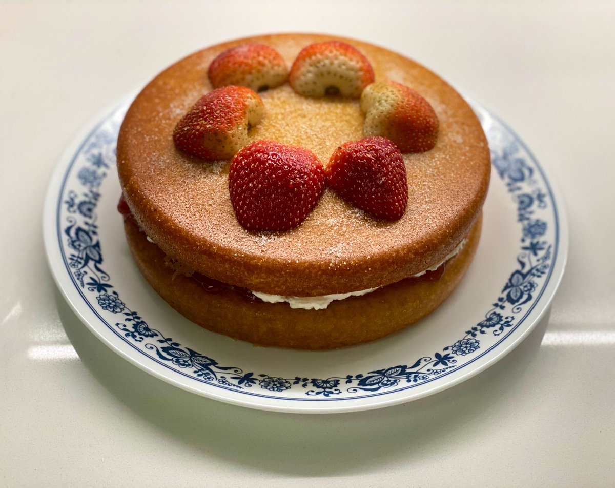 Victoria Sponge Cake with strawberries on a plate.
