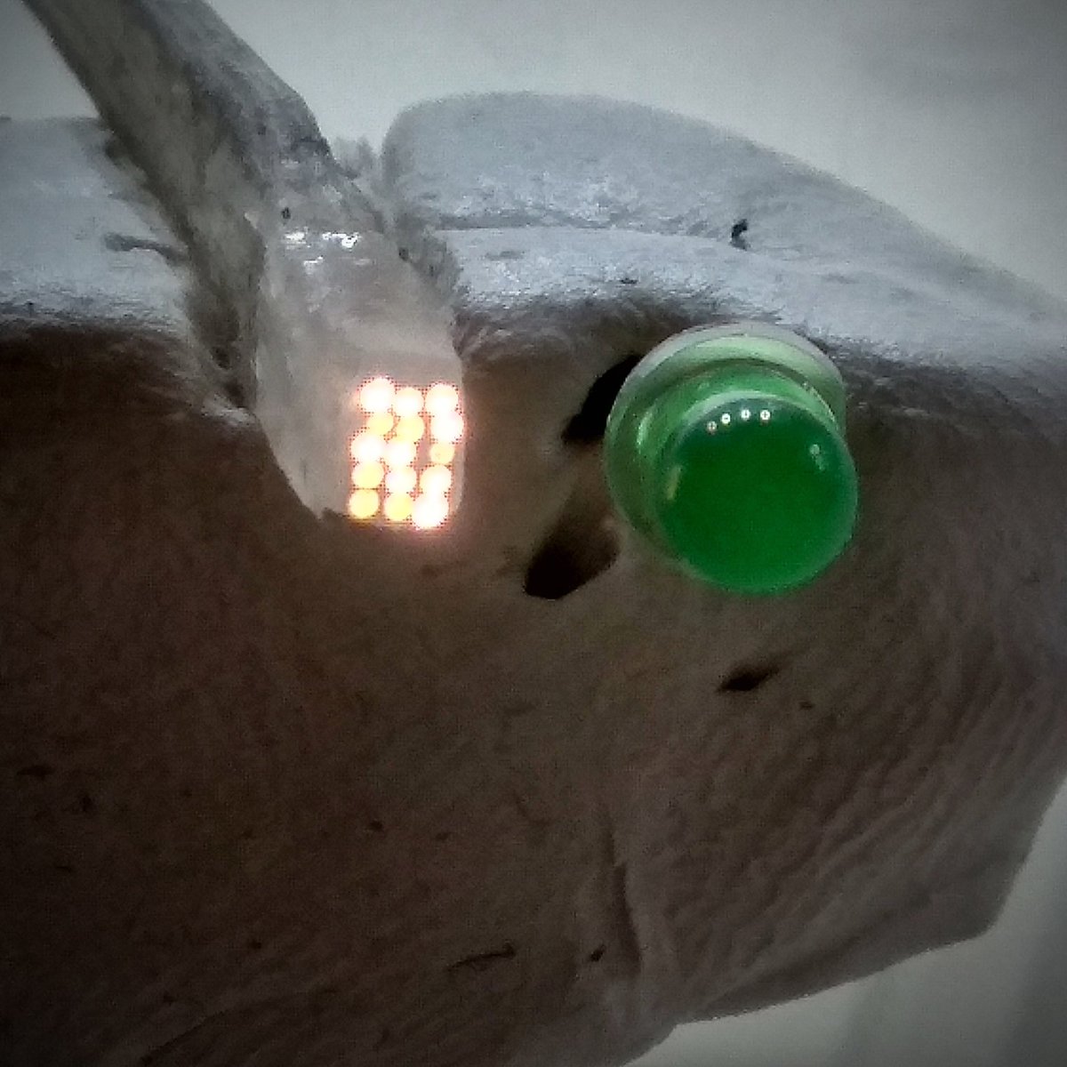 matseng's tweet image. I've tried to make a *tiny* 3x5 pixel display using optofibres connected to 15 LEDs. But crazyglueing/hotsnotting them to SMDs is  really hard. And using 3/5mm regular with a drilled hole also fails.  #failOfTheWeek (There'd a 3mm LED on the photo for size comparison)