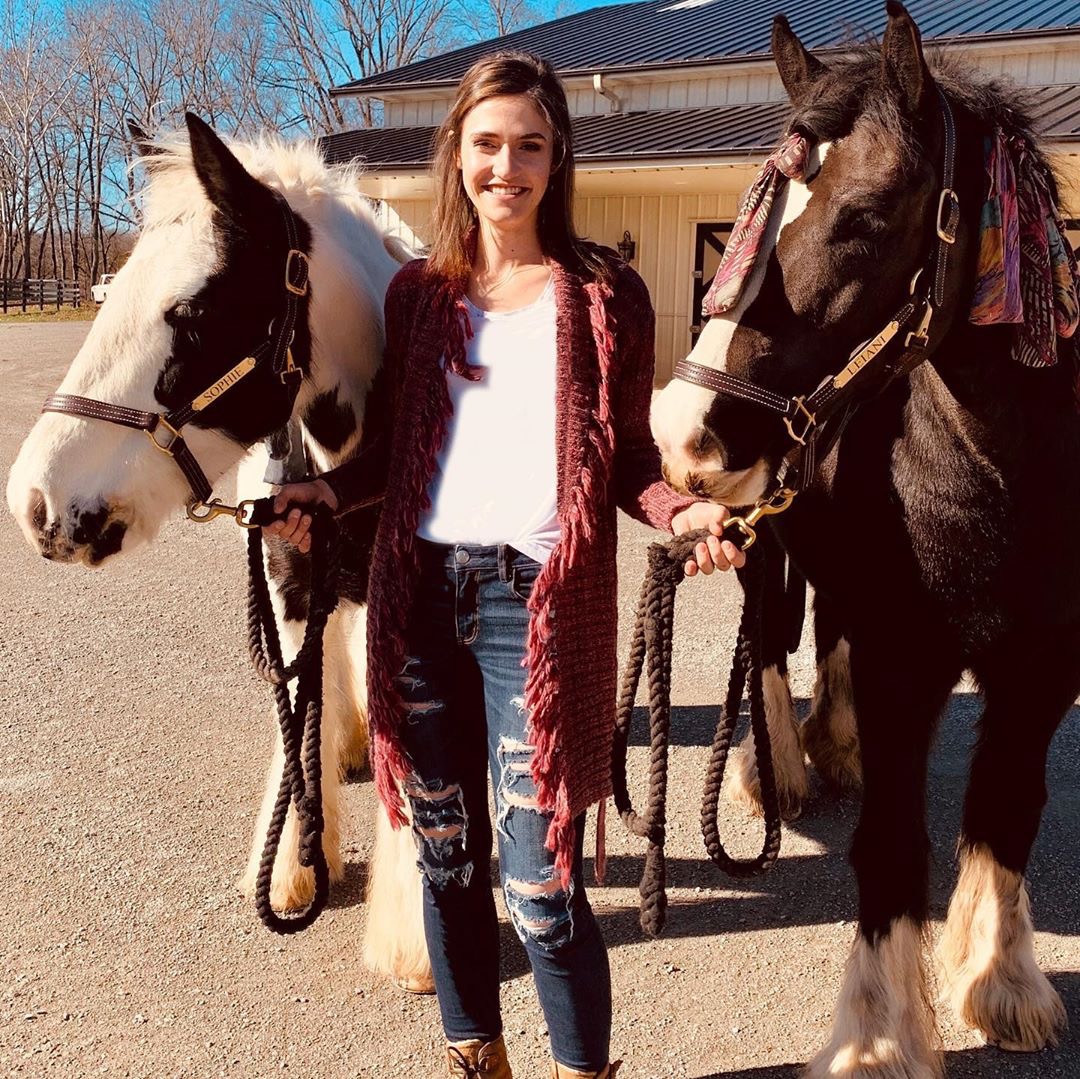 mirandalambert's tweet photo. This is my friend Julia. She takes care of all my fur babies everyday &amp; her own 1 year old sweet baby boy Waylon. She was helping me and @ashleymonroe tack up our horses for a trail ride yesterday and she just looked so dang cute (in her @idyllwind sweater 💗)I had to snap these. https://t.co/8HTP5HImy8