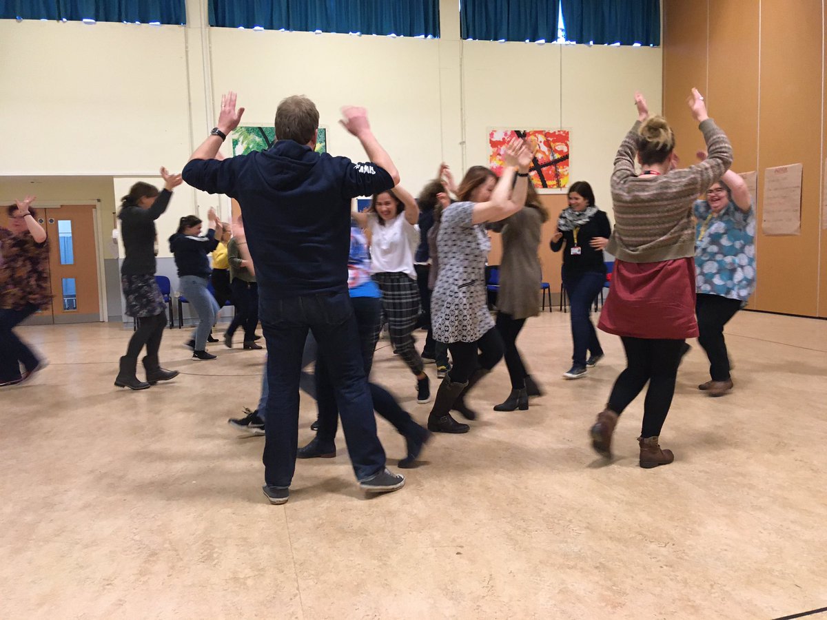 Group of people in room running around