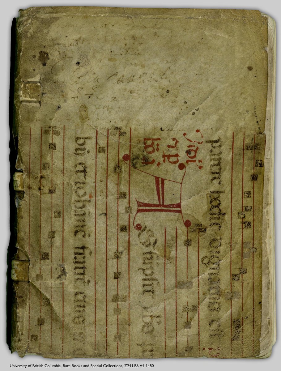 Photo of the cover of an incunable (early printed book). The top board has been covered with a recycled leaf from a medieval musical manuscript. The musical staves—consisting of 4 red lines with black neumes (a form of early music notation)—are oriented vertically, and include lyrics copied in black ink with an enlarged decorative majuscule in red. The book is: UBC, RBSC, Z241.B6 V4 1480.