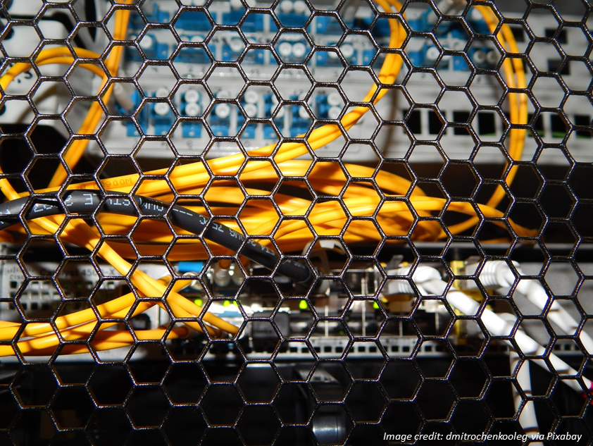 Close-up photo of server and router with tangle of coiled network cables. Image credit: dmitrochenkooleg via Pixabay.