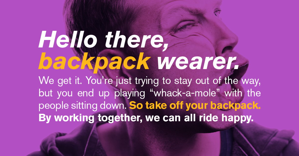 A rider getting accidentally hit with a backpack a fellow rider is wearing. 