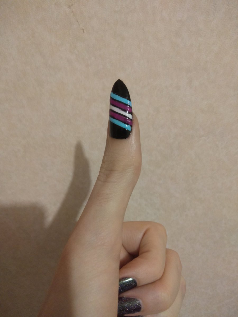 Thumbs up, thumbnail is painted black with the trans flag painted diagonally across the middle.