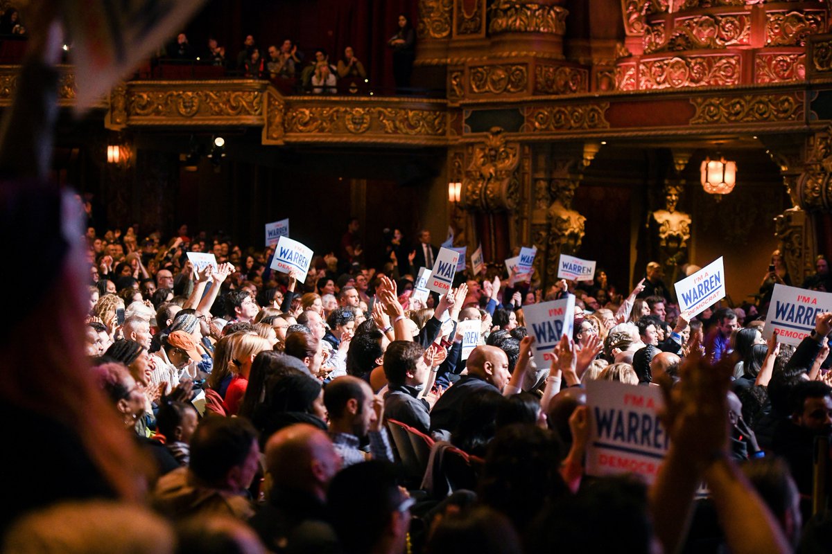 Supporters cheer for Elizabeth Warren and Julián Castro.