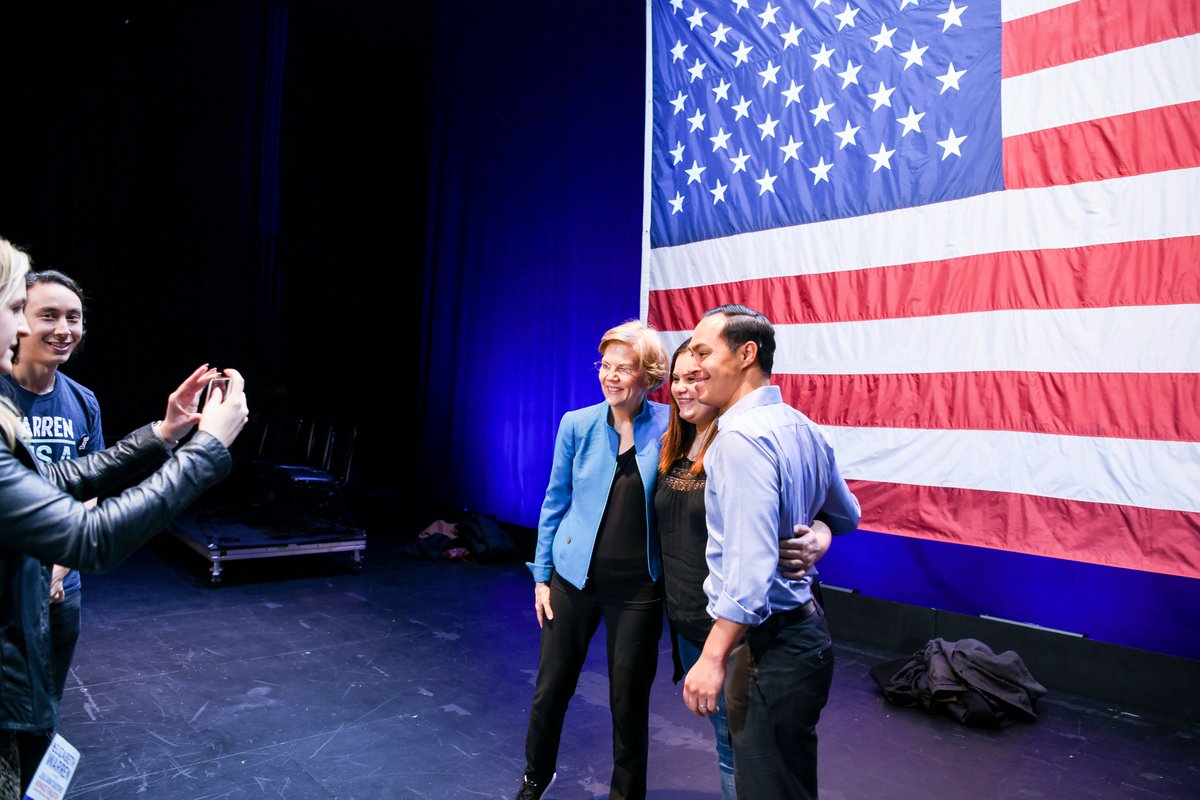 Elizabeth Warren and Julián Castro take a photo with a supporter.