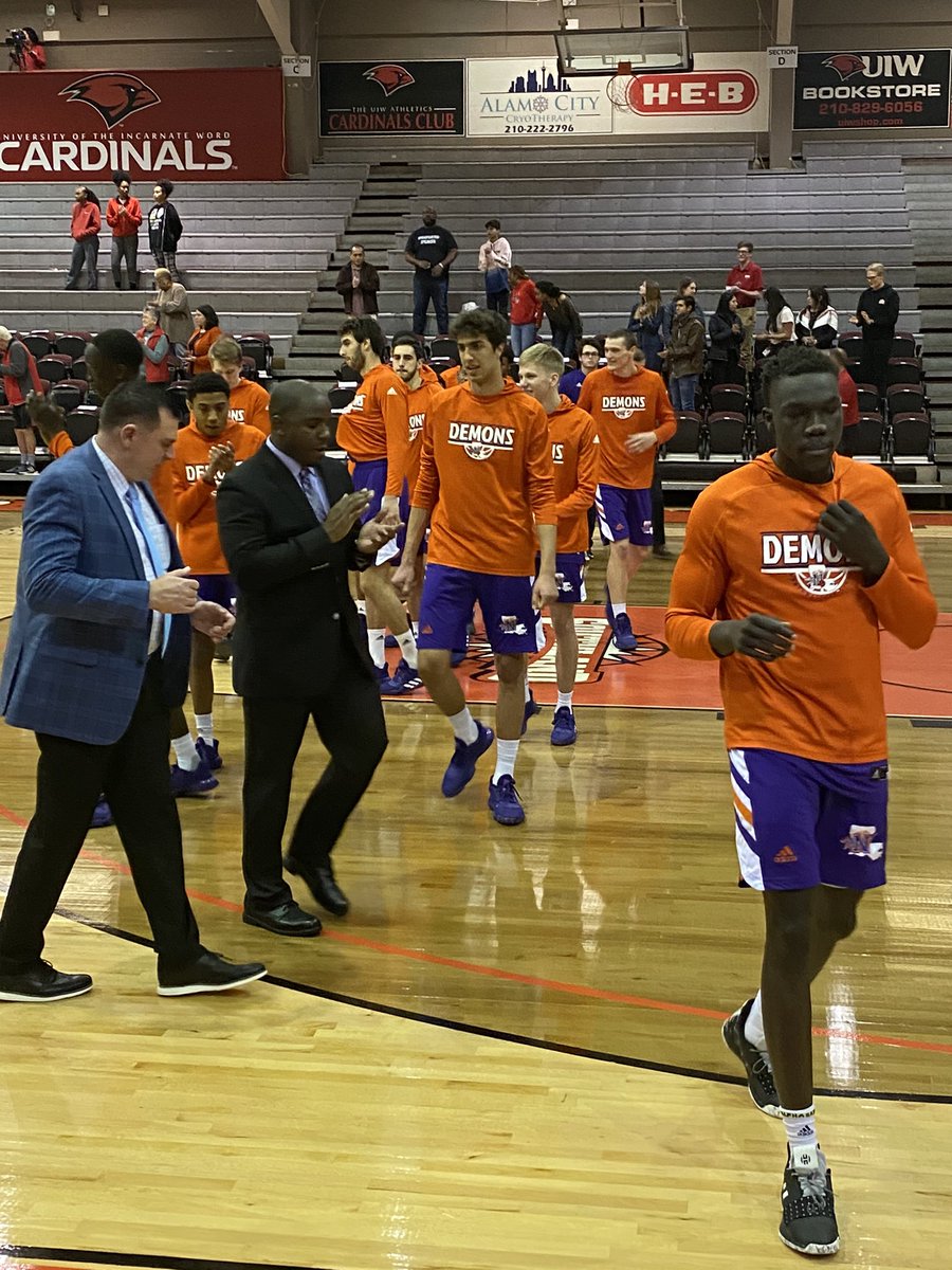 CoachJohnASmith's tweet photo. Such a blessing for my mentor Mike McConathy &amp; my mother to catch up tonight as we supported the @NSUDemonsMBB @NSUDemons in their victory tonight in San Antonio.  Thank you for everything Coach Mike, forever indebted. 🟣🟠😈🏀🤘🏾 #DemonsOfDestiny #Alumni #NCAAtournamentEra https://t.co/ZDRiBhYBxu
