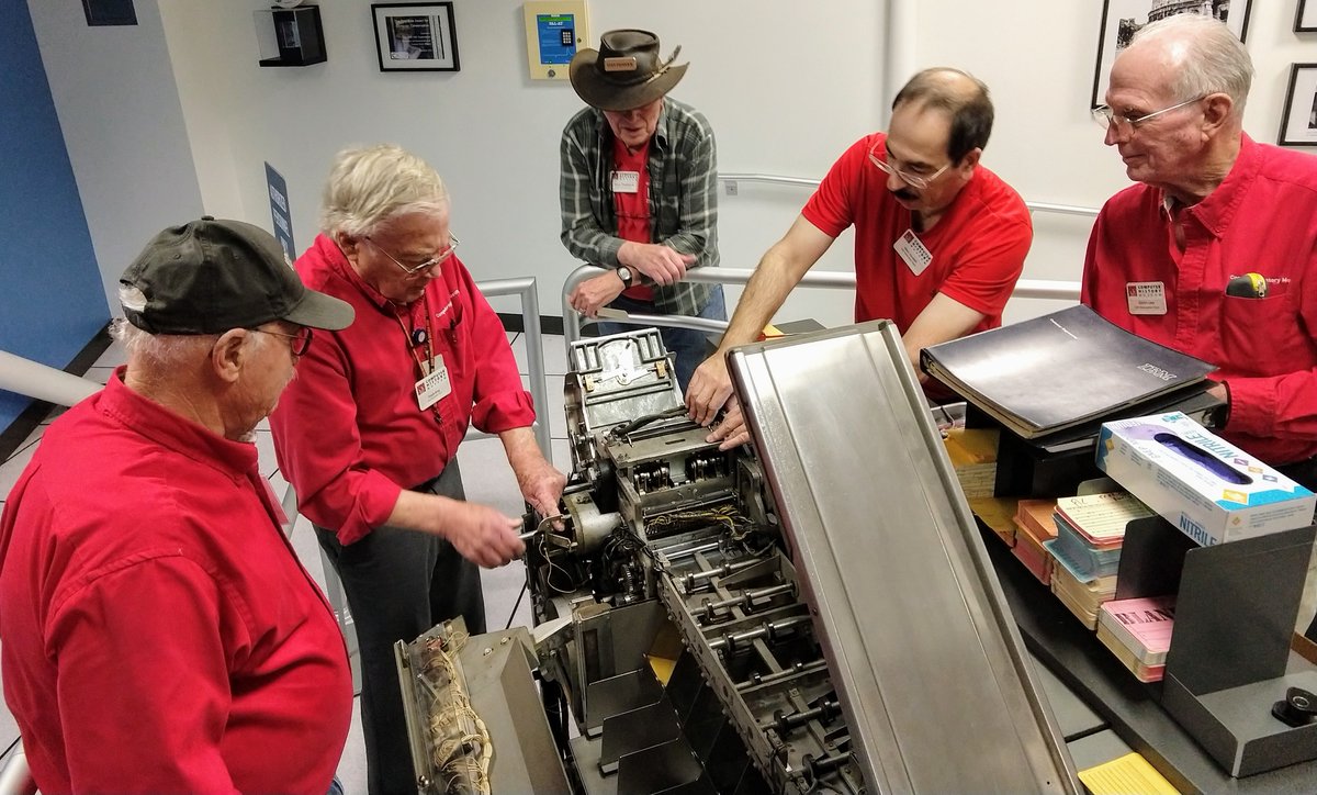 Volunteers at the Computer History Museum repairing the IBM 1402 card reader/punch.