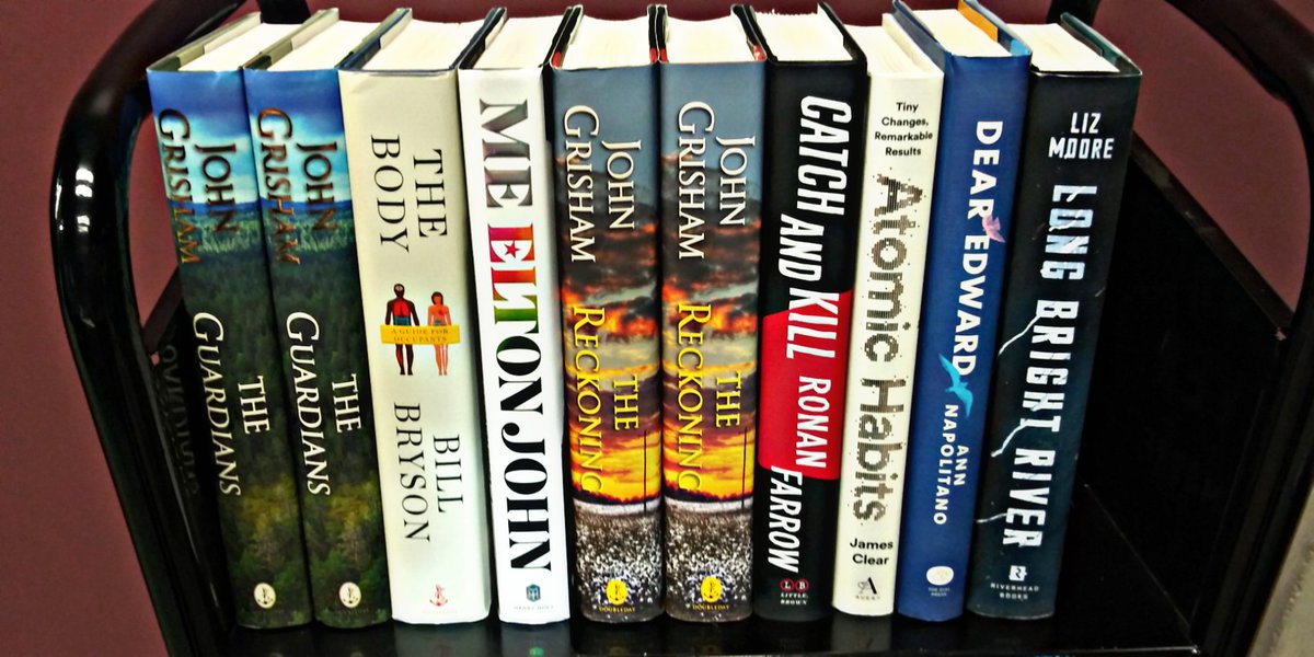Ten hardcover books with various titles and authors.