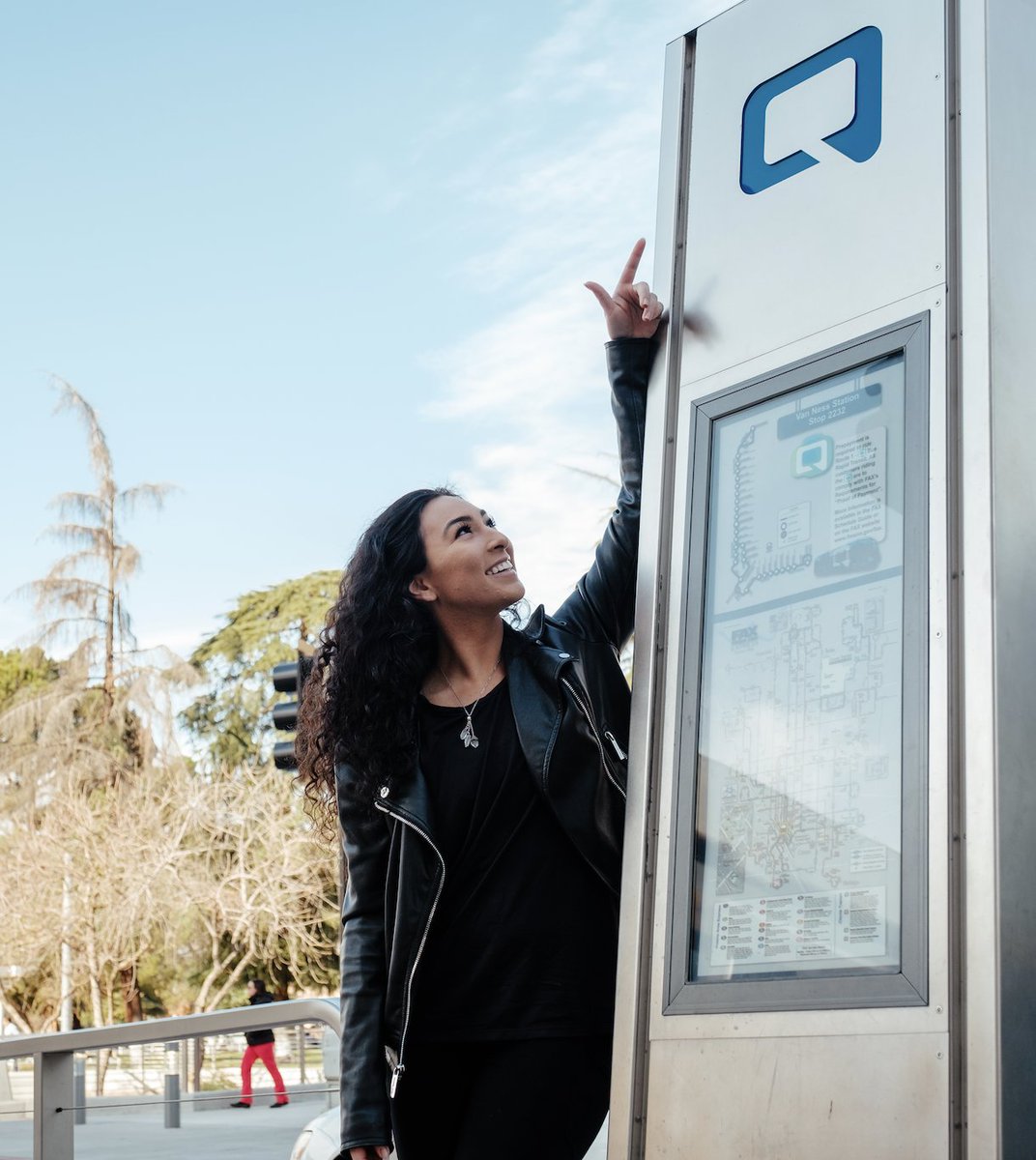 Woman viewing "the Q" map