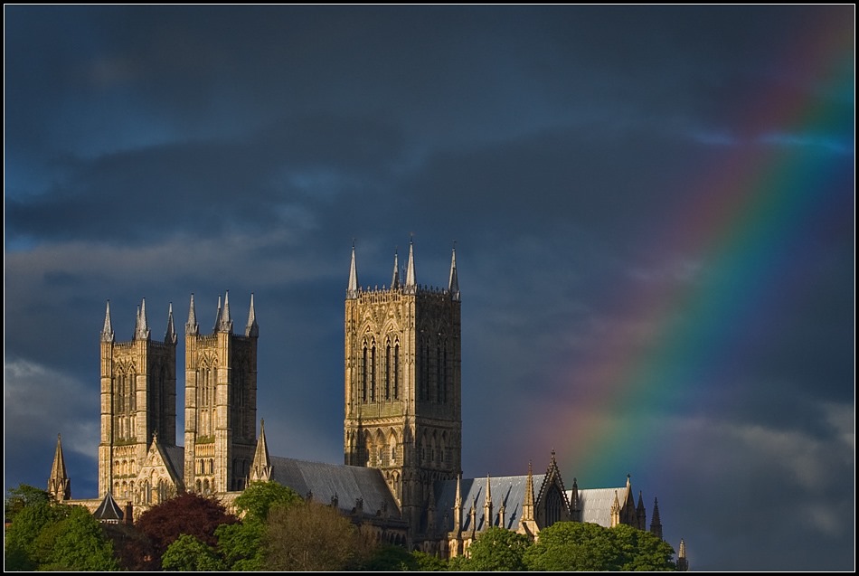 A view of the Cathedral with a wonderful rainbow next to it in the sky.