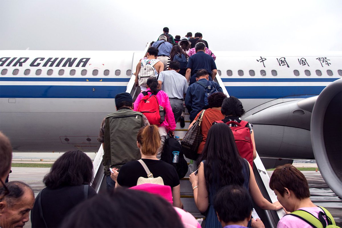 Passengers boarding an Air China plane at the Beijing Airport. Credit: Edwin Remsberg / Alamy Stock Photo.