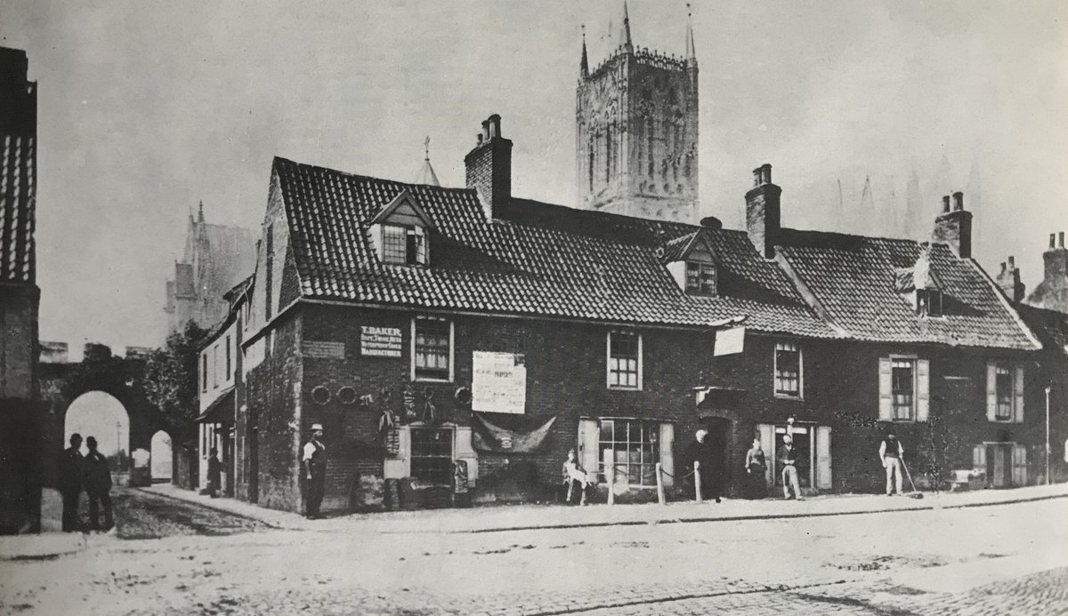 An old picture of the East Green filled with houses in the late 19th century