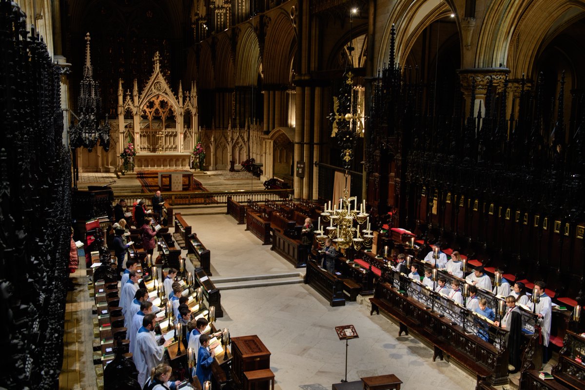 A view of the wonderful St Hughs Choir with the choir singing away on the benches.