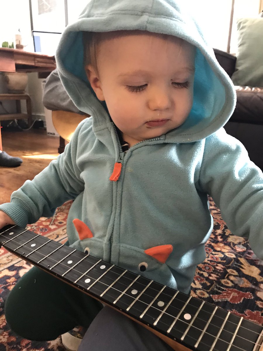 Our little rose bud is studying the frets. He loves him some banjo! #babiesandbanjos