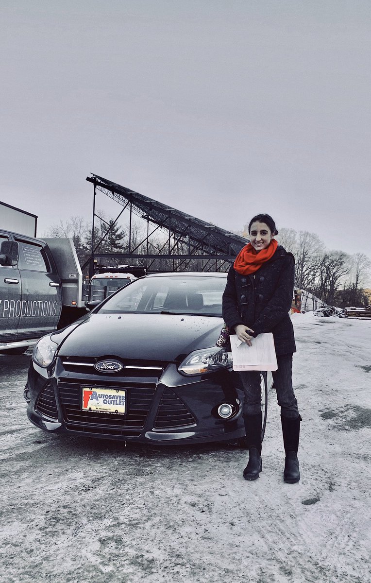 Me standing in front of my new black Ford Focus. Red scarf.
