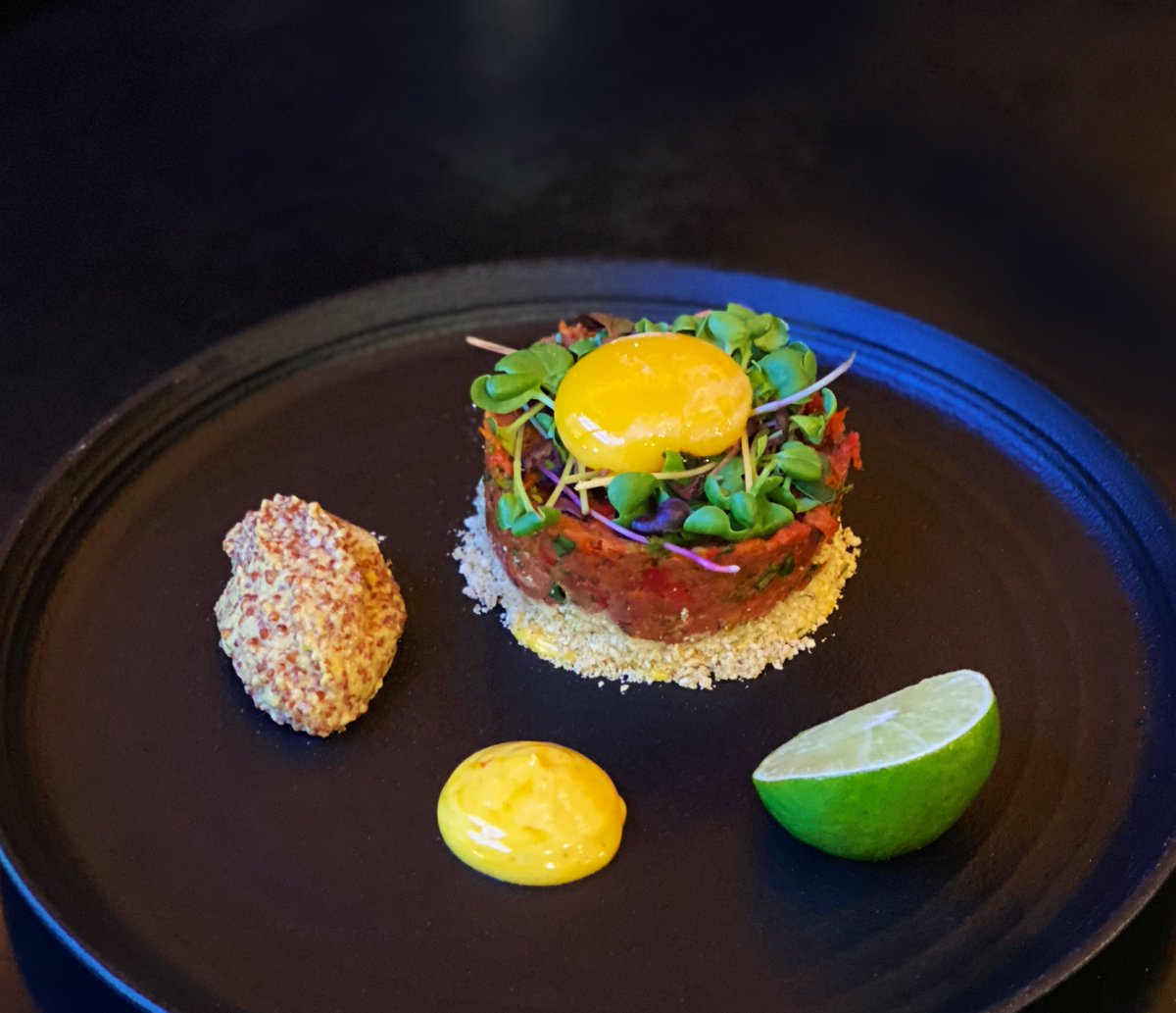 CityTable's tweet image. This evening's special: beef tartare on a bed of crushed crackers, served with confit egg yolk, microgreens, whole grain mustard, and saffron aioli. 🍴