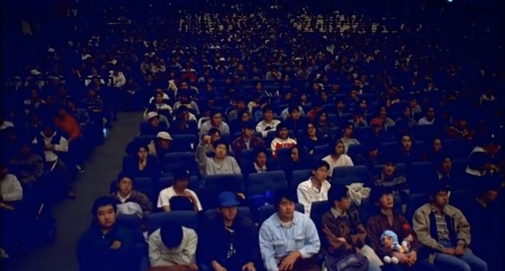 The live action form also allows Hideaki Anno to make a larger, more meta point about the audience itself. As we could see in this shot of people in the theatre