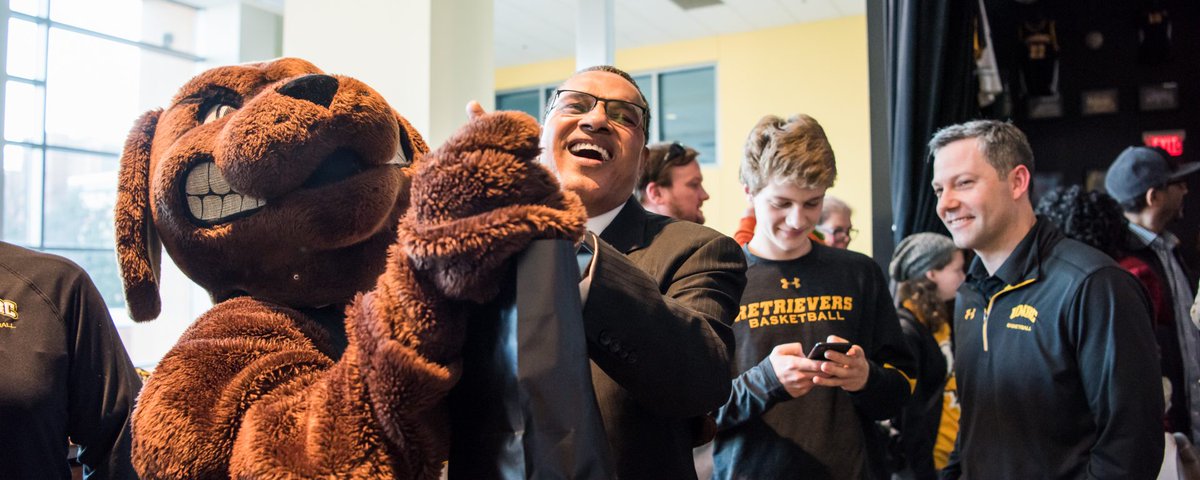 President Hrabowski dancing with Chesapeake Bay Retriever mascot