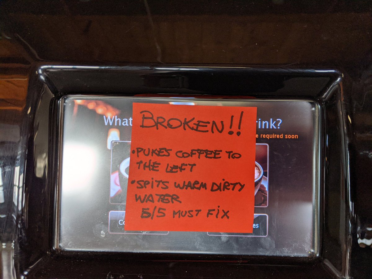 Photo of a coffee machine with a post-it note covering the touch screen interface, reading:

"BROKEN!!
• Pukes coffee to the left
• Spits warm dirty water
5/5 Must Fix"